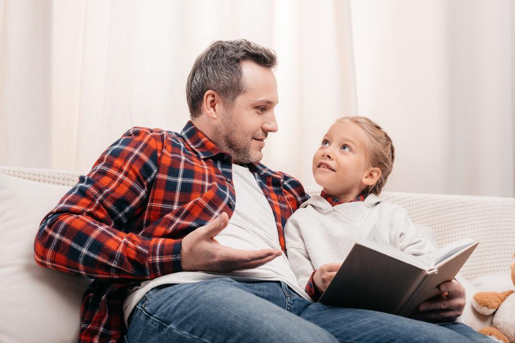 father and daughter reading book - Photo, Image