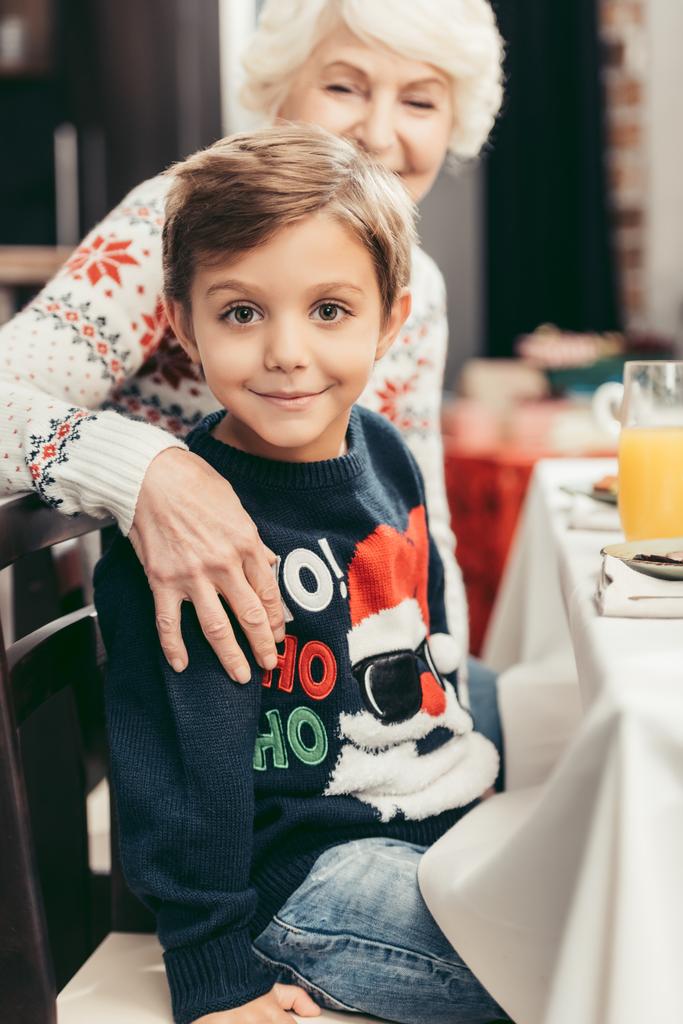 grandmother and grandson sitting at christmas table - Photo, Image