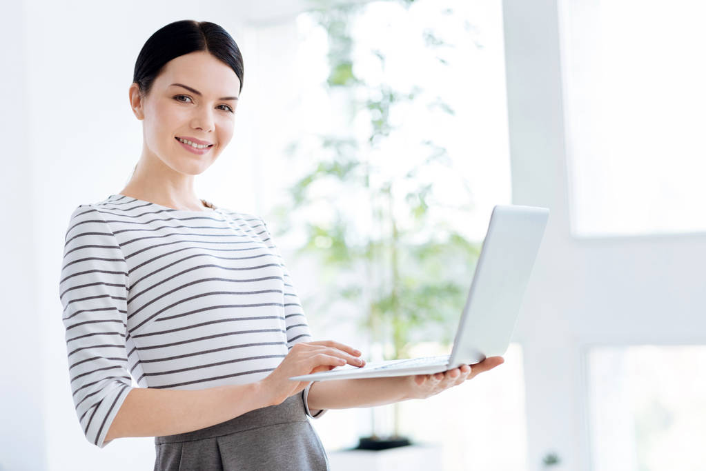 Smart confident businesswoman using a laptop - Photo, Image