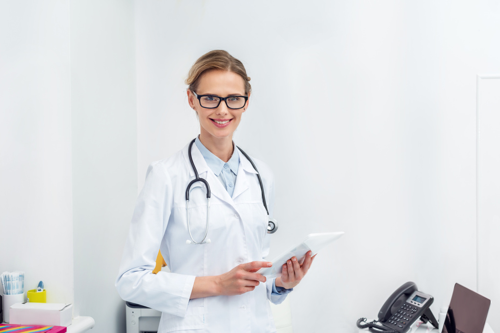 Женщина-врач с помощью цифрового планшета - Фото, изображение