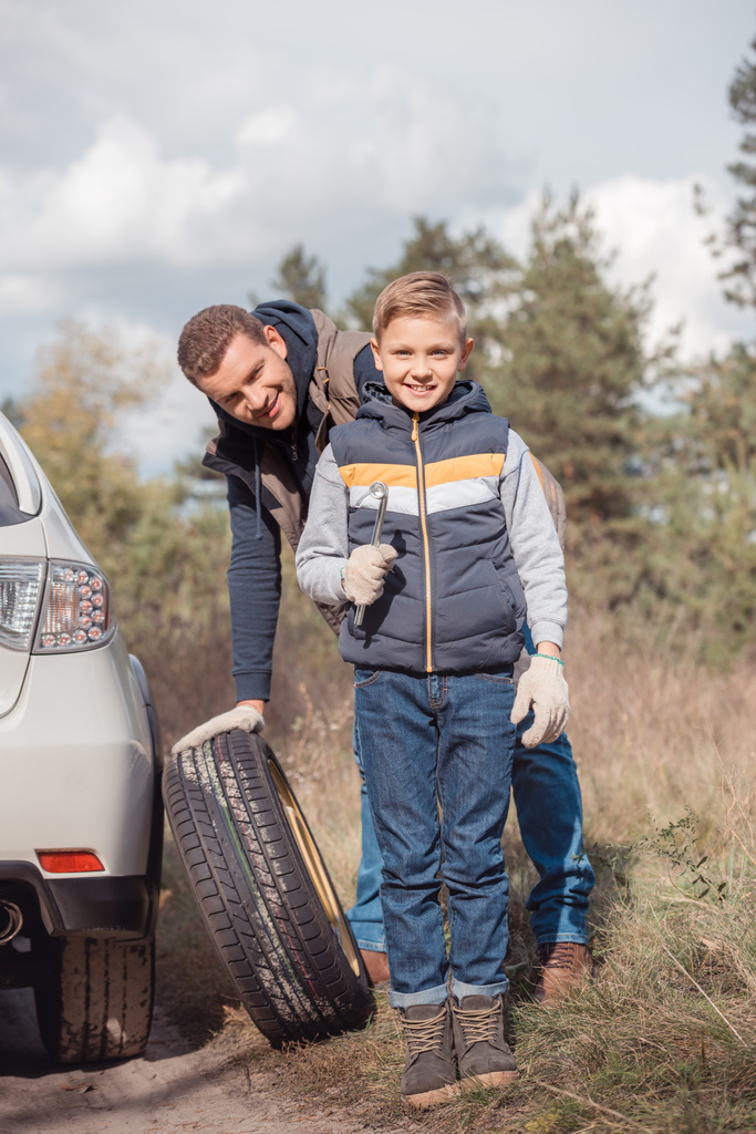 Father and son changing car wheel - Photo, Image