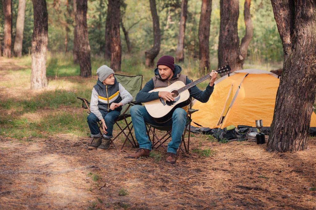 father and son with guitar in forest - Photo, Image