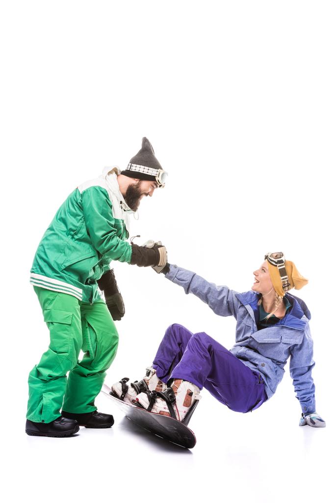 сноубордист допомагає дівчині вставати
 - Фото, зображення