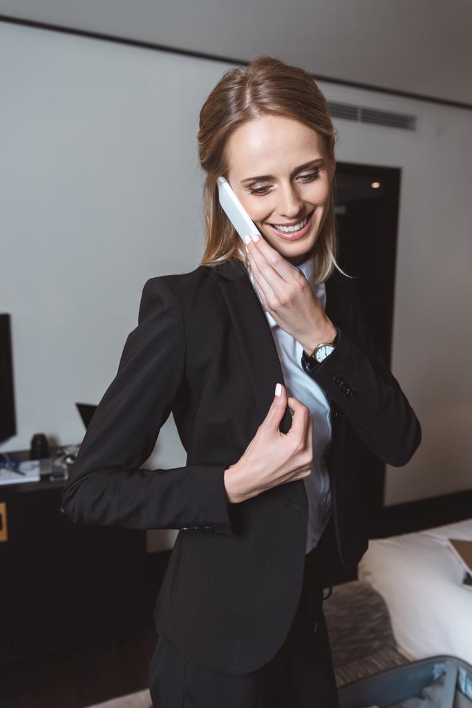 businesswoman using smartphone in hotel room - Photo, Image