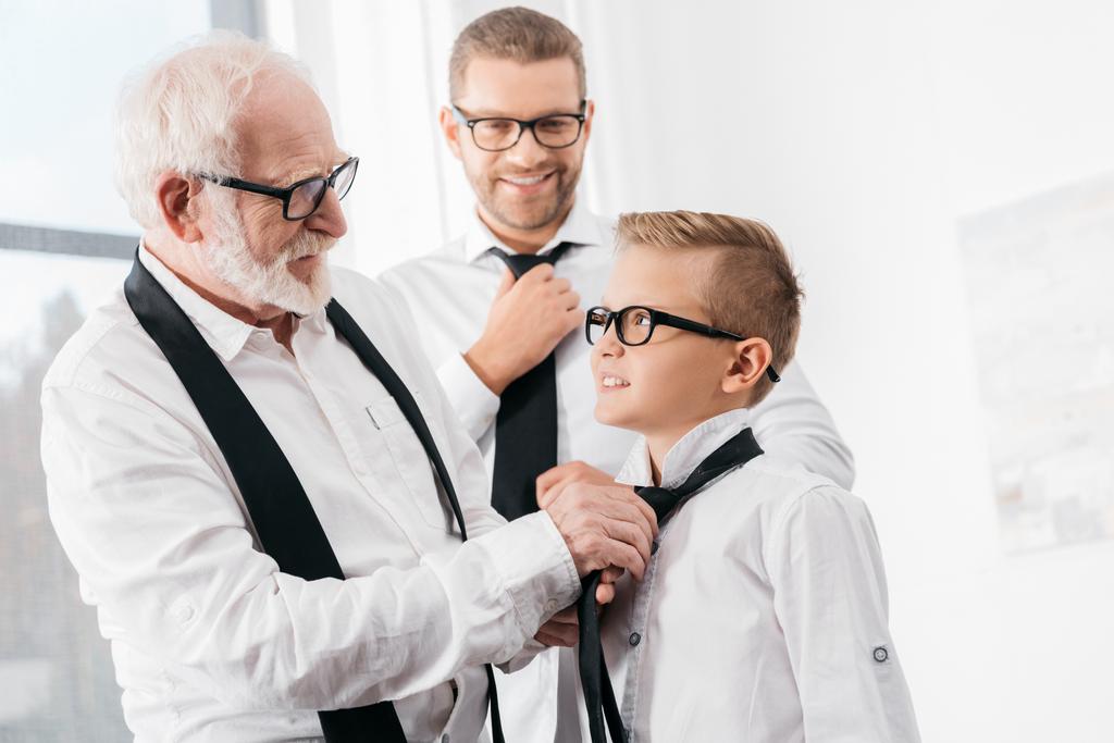 grandfather helping grandson with tie - Photo, Image