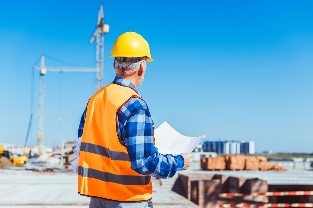 construction worker holding building plans - Photo, Image