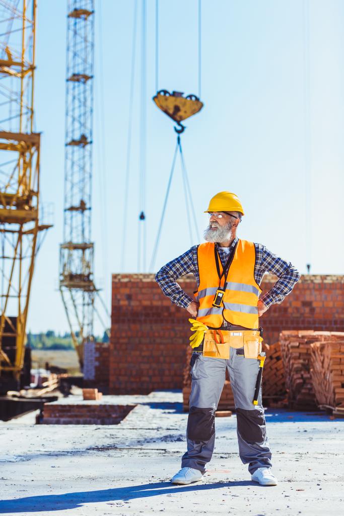 Arbeiter in Uniform steht auf Baustelle - Foto, Bild