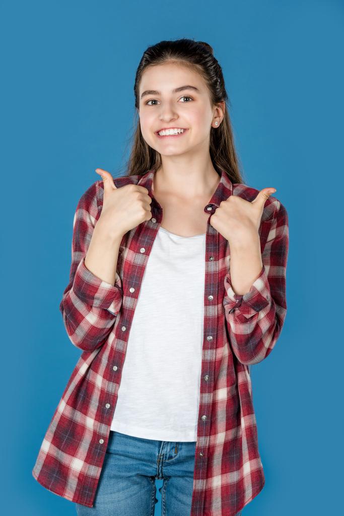дівчина-підліток показує великий палець вгору
 - Фото, зображення