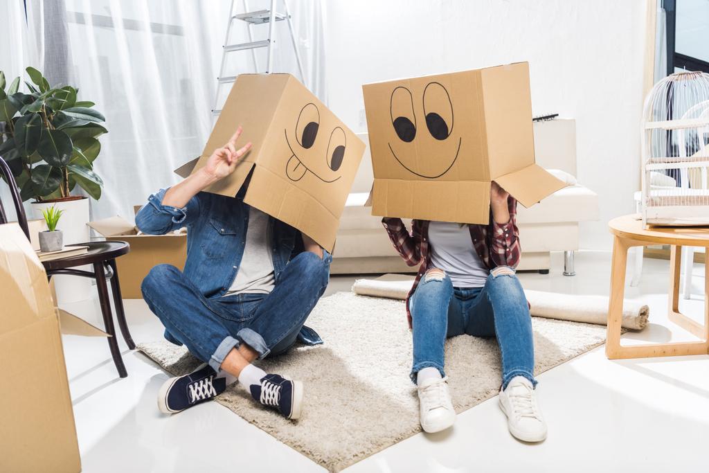 couple with boxes on heads - Photo, Image