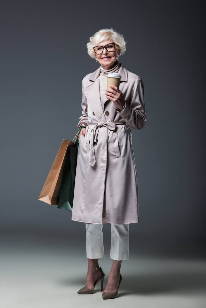 senior lady with shopping bags and coffee - Photo, Image