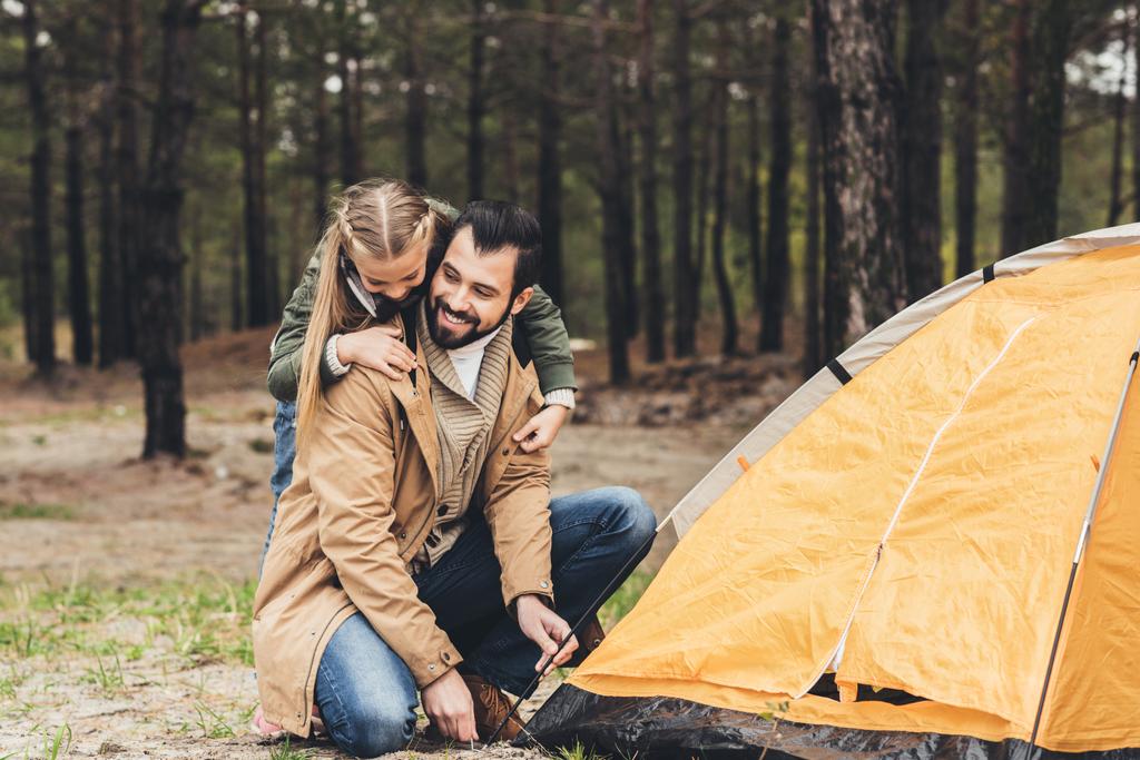 father and daughter installing tent - Photo, Image