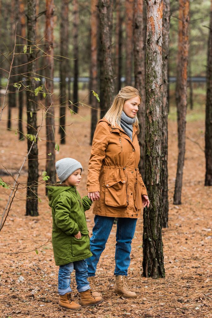 mother walking by forest with son - Photo, Image