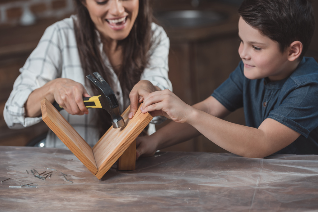 Mother and son crafting birdhouse - Photo, Image
