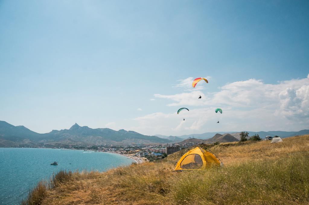 people flying on paragliders at sea - Photo, Image