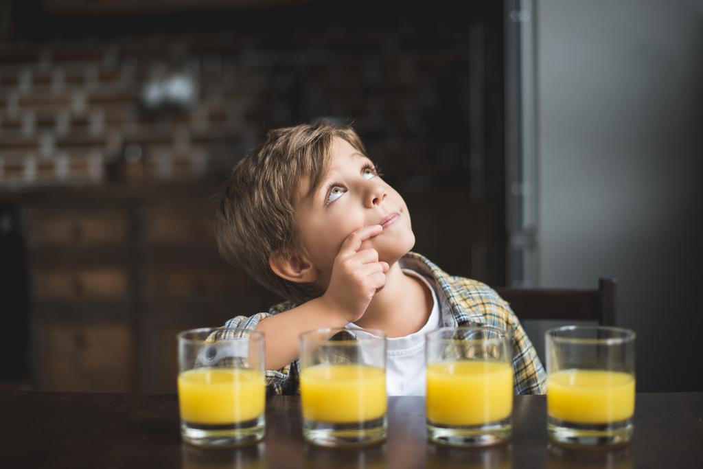 child at table with glasses of juice - Photo, Image