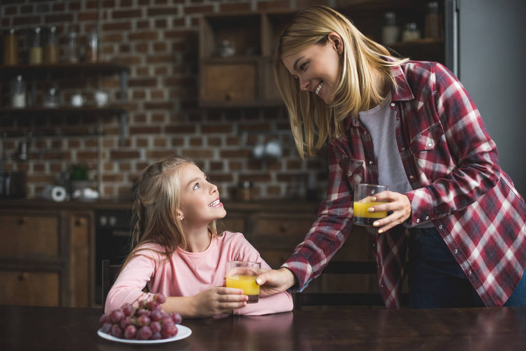 mother and daughter having breakfast - Photo, Image