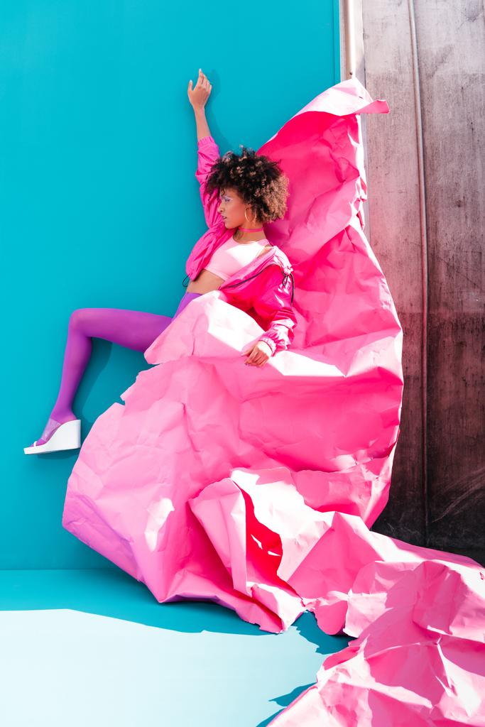 дівчина позує з рожевим папером
 - Фото, зображення