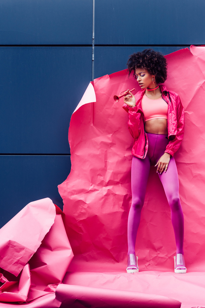 fashionable model posing with pink paper - Photo, Image