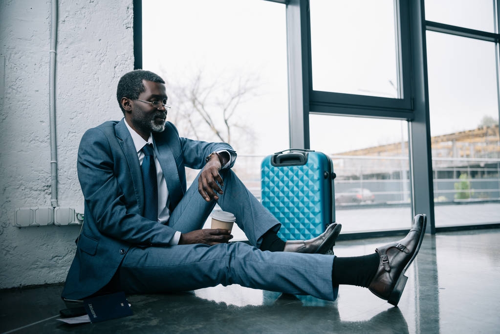 businessman sitting on floor at airport - Photo, Image