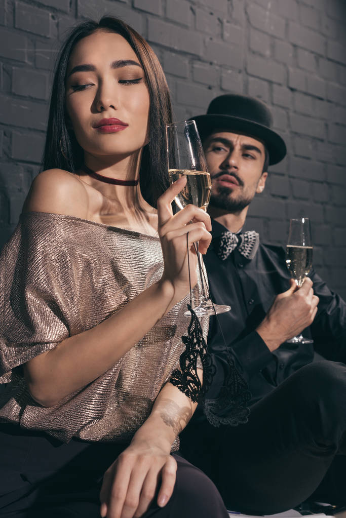 multiethnic couple with glasses of champagne - Photo, Image