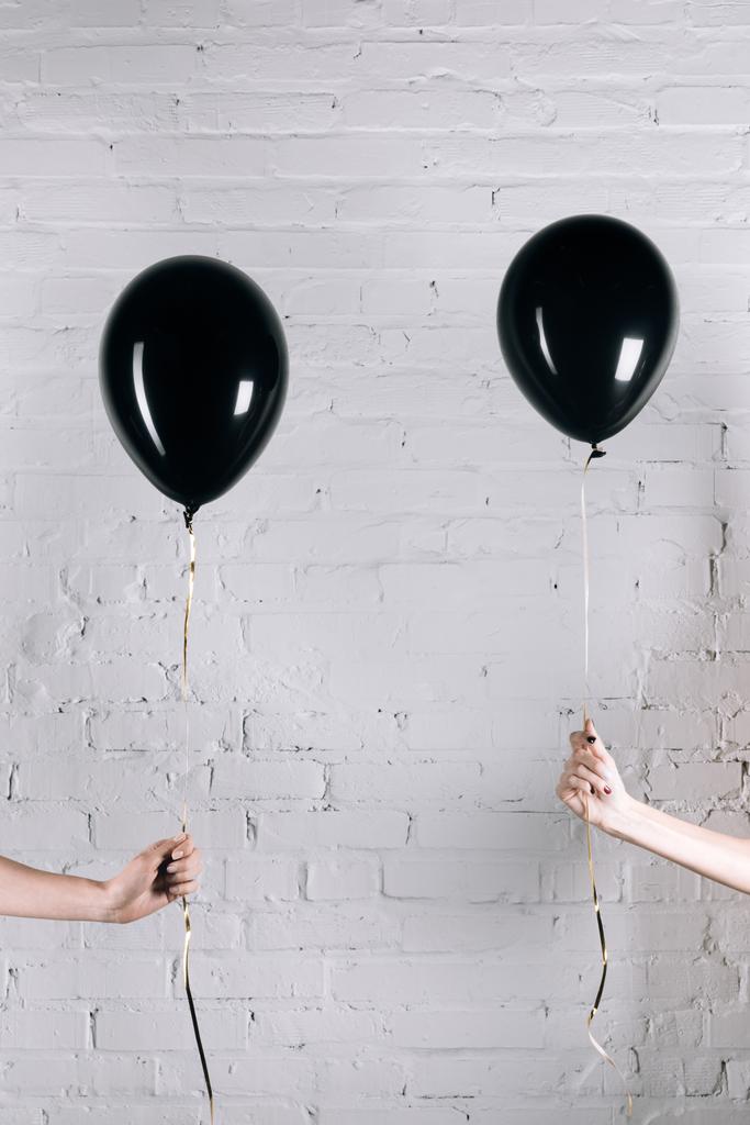 women holding black balloons - Photo, Image