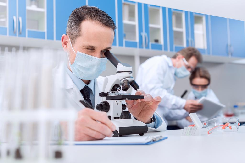 Scientist working with microscope - Photo, Image