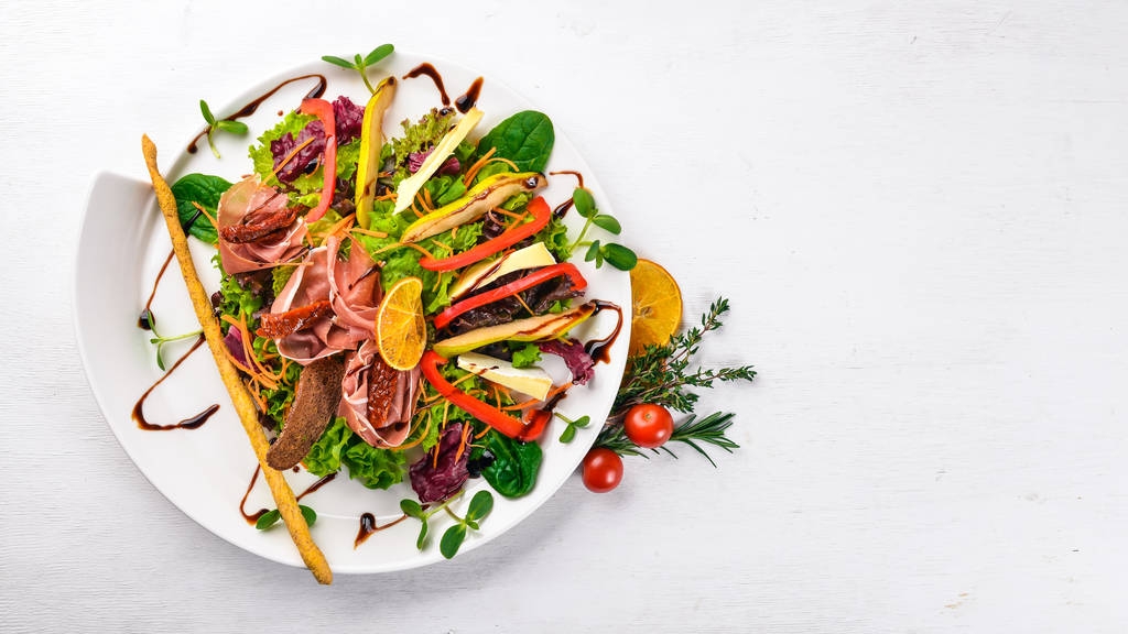 Salad with meat and salad leaves. On a wooden surface. Top view. Free space for your text. - Photo, Image