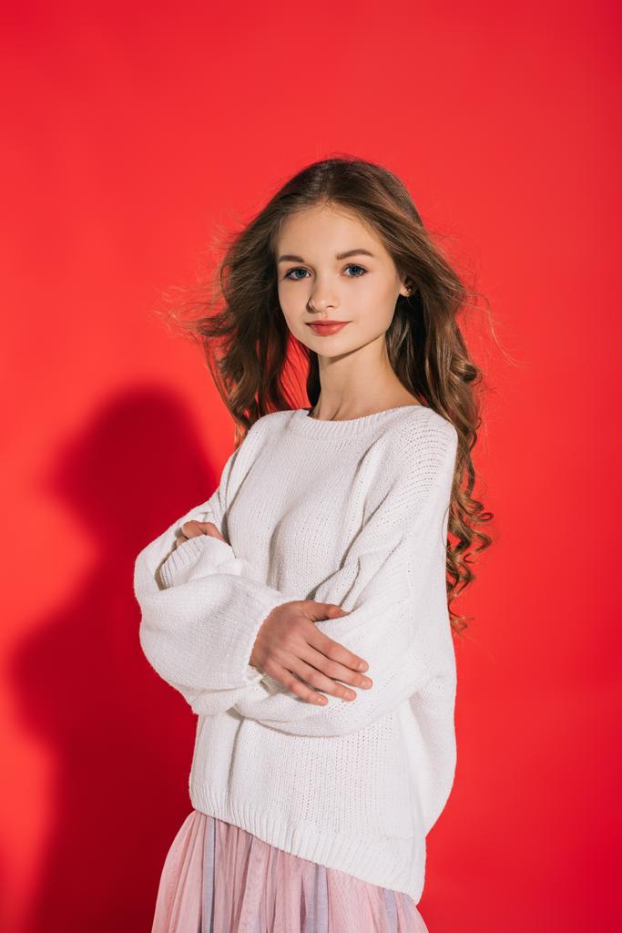 白いセーターの赤のカメラに笑顔で美しい十代の少女 ロイヤリティフリー写真・画像素材
