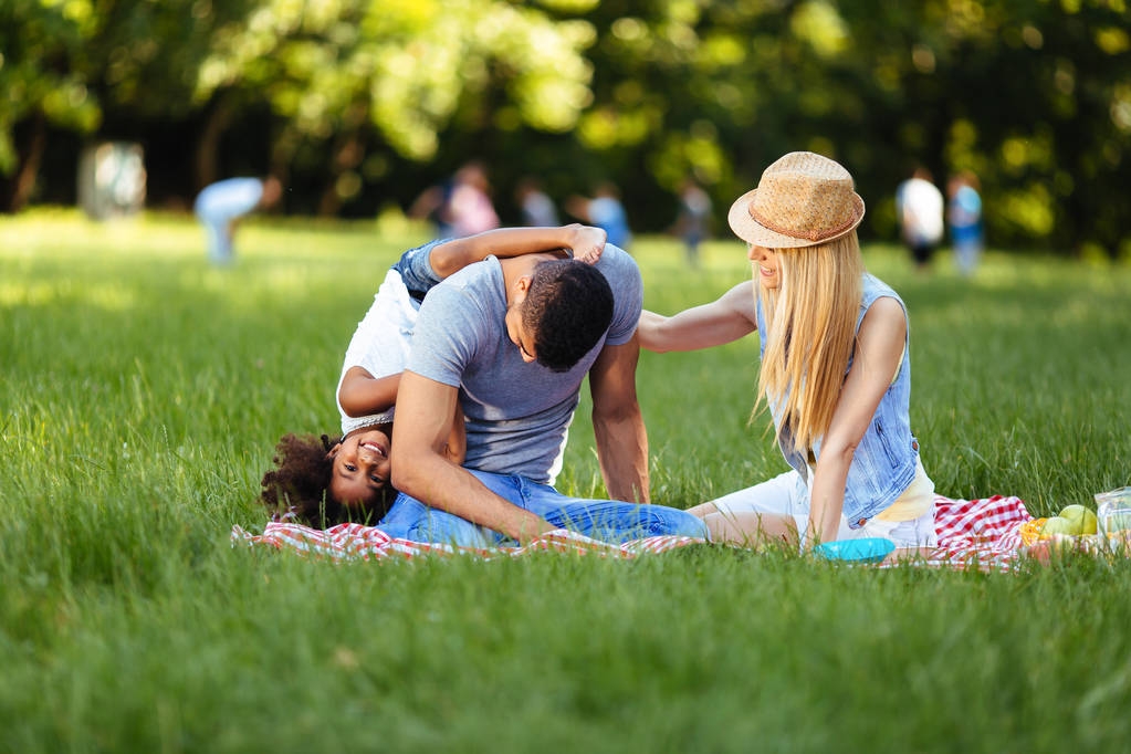 couple with their daughter having picnic - Photo, Image