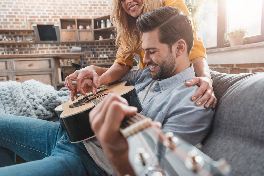 couple playing guitar together - Photo, Image