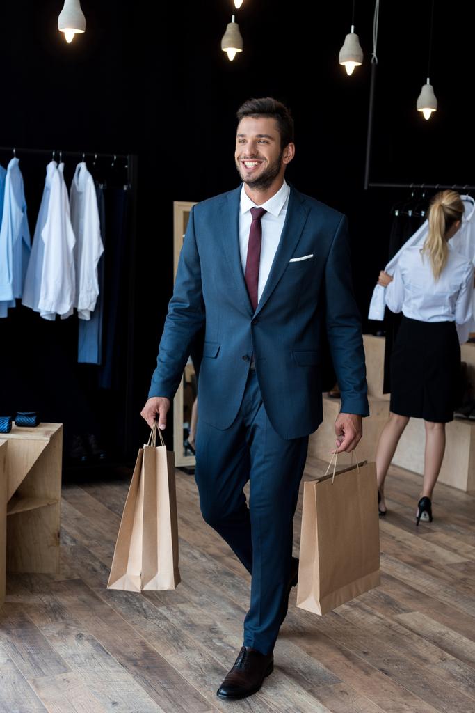 businessman with shopping bags in boutique - Photo, Image