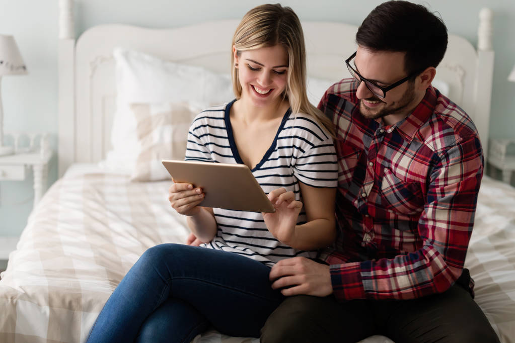 couple using tablet in bedroom - Photo, Image