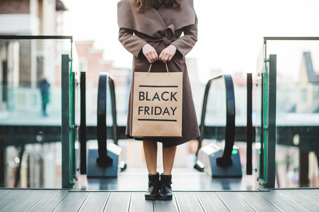 Woman holding Black Friday paper bag - Photo, Image