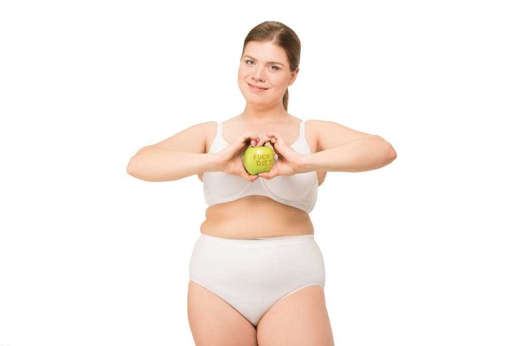 donna in sovrappeso in biancheria intima che tiene mela
  - Foto, immagini