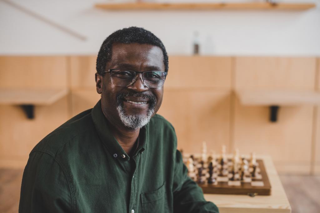 smiling mature man with chess - Photo, Image