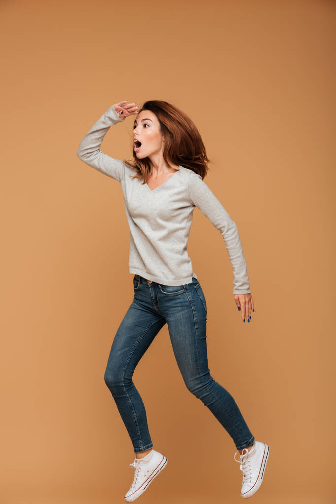 Full length photo of amazed young woman in casual wear jumping o - Photo, Image