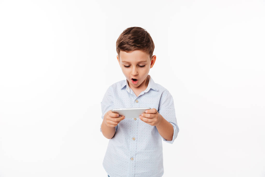 Portrait of an amused cute little kid playing games - Photo, Image