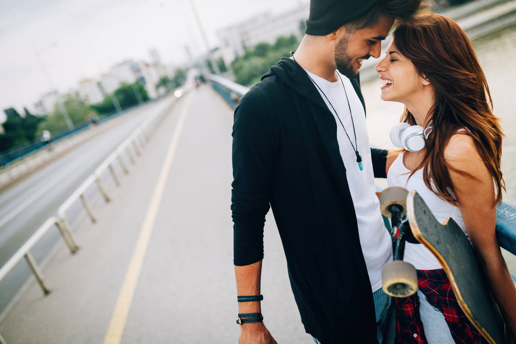  attractive couple carrying skateboards - Photo, Image