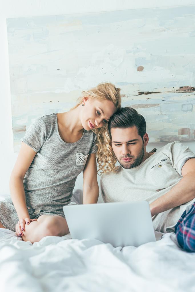 couple using laptop in bed - Photo, Image