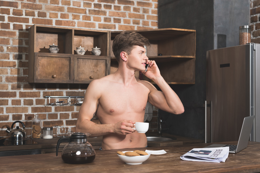 man talking by phone on kitchen - Photo, Image