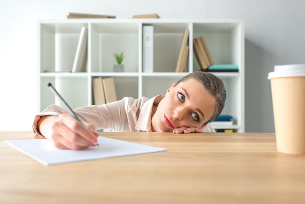 tired businesswoman lying on table - Photo, Image