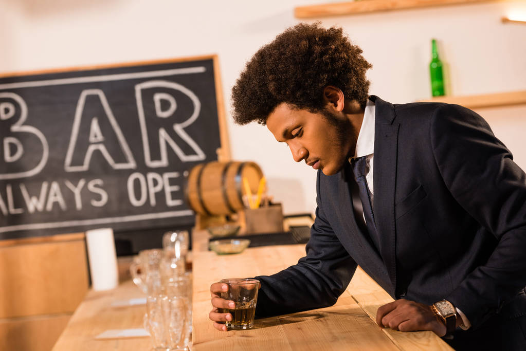 ウイスキーを飲むアフリカ系アメリカ人のビジネスマン - 写真・画像