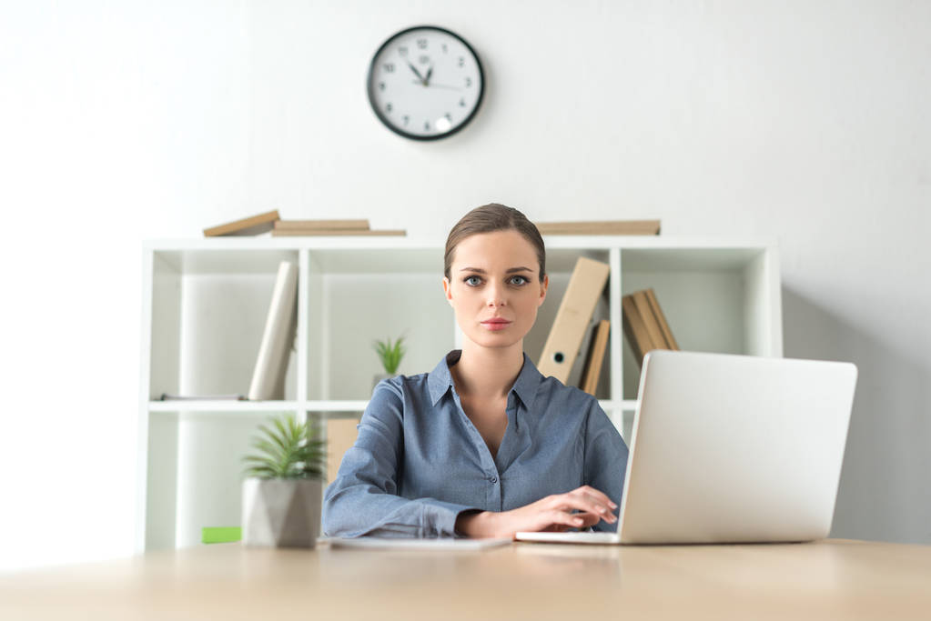 Серйозна бізнес-леді з ноутбуком
 - Фото, зображення