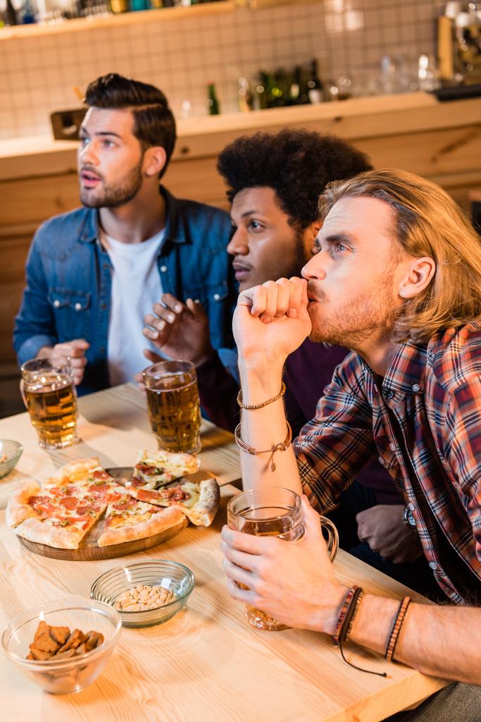 friends with pizza and beer in bar - Photo, Image