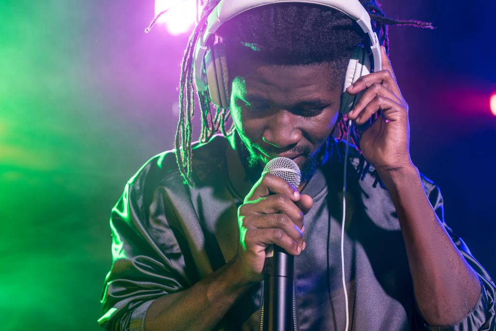 DJ in headphones with microphone on concert - Photo, Image