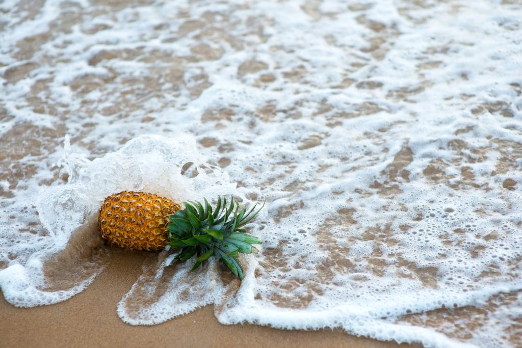 pineapple fallen by ocean wave - Photo, Image