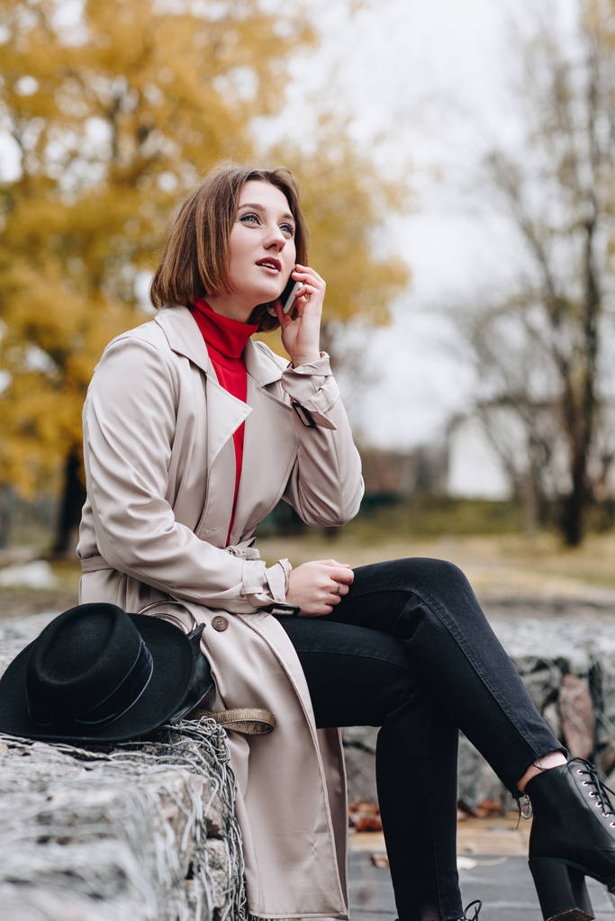 woman talking by phone in park - Photo, Image