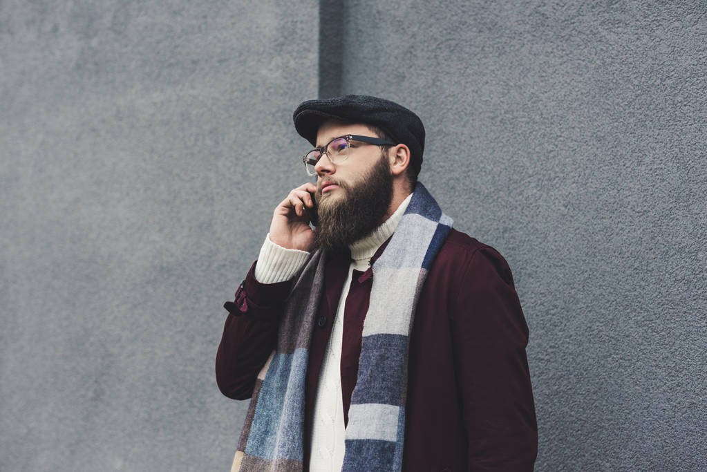 Бородатий чоловік розмовляє по телефону
 - Фото, зображення