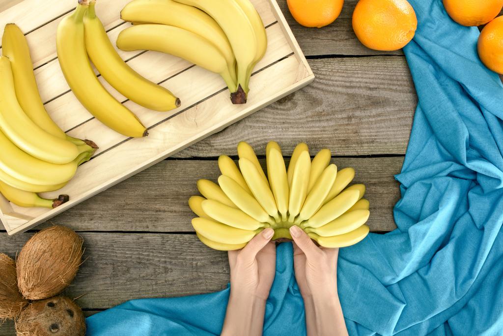 bunch of bananas in hands - Photo, Image