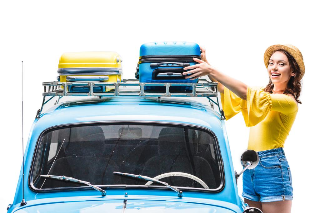 woman putting luggage on car roof - Photo, Image